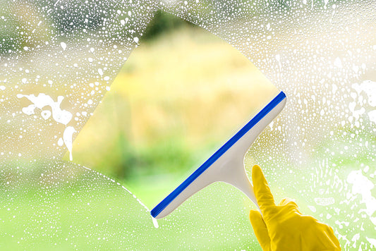window squeegee cleaning a soapy window