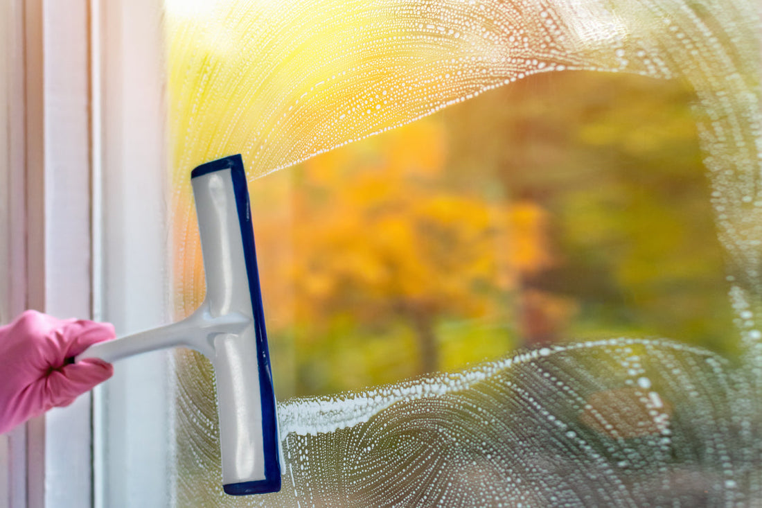 window squeegee clearing water from a window