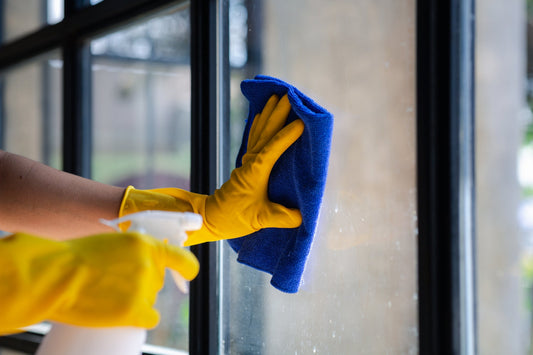 close up of window cleaner using a microfiber towel