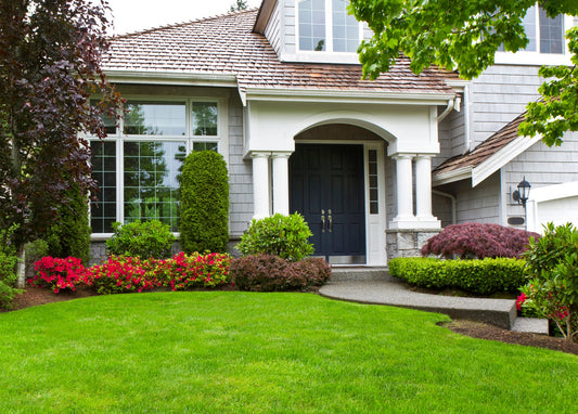 house with beautiful landscaping and large windows