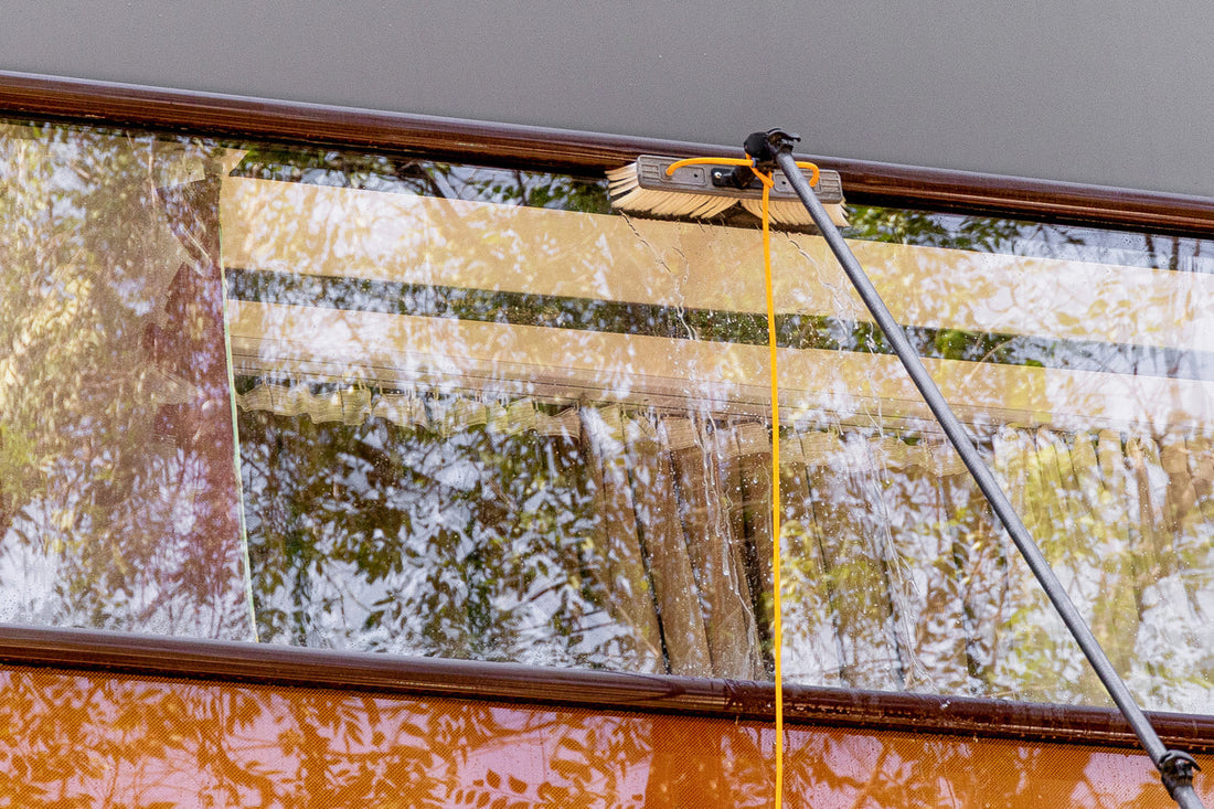 water brush cleaning windows on a modern building facade