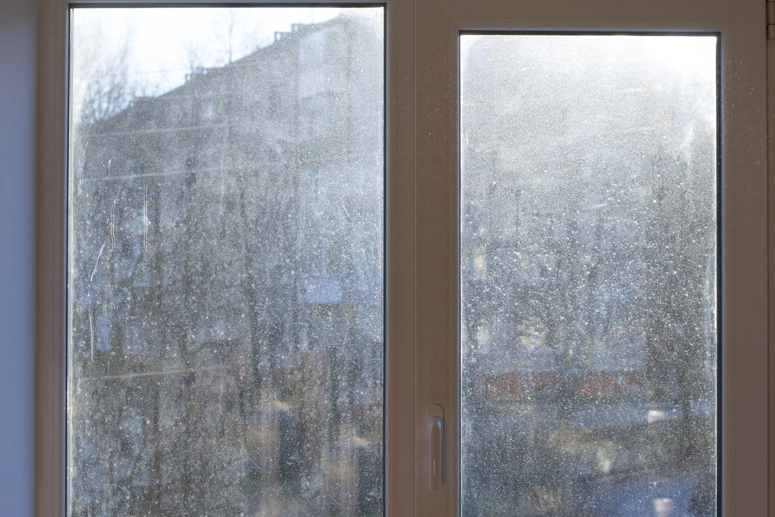large window with hard water and salt stains